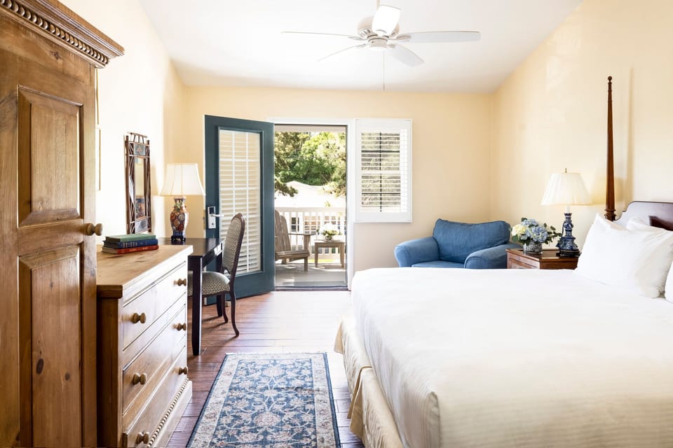 A charming bedroom with rustic touches and private patio access for a peaceful retreat.