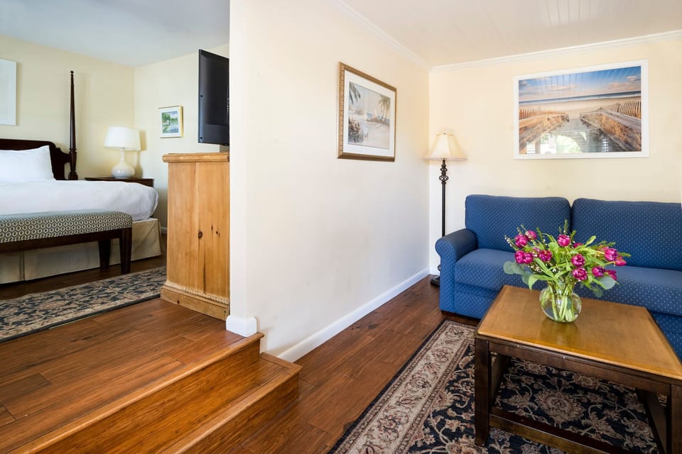 A welcoming suite with warm wood flooring and a cozy seating area for ultimate relaxation.