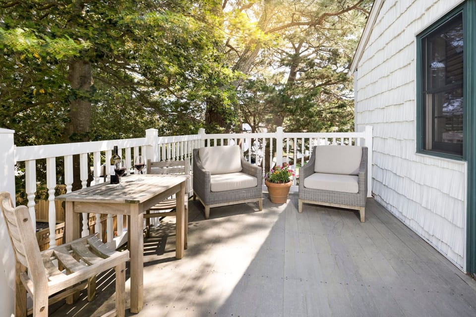 A serene outdoor balcony with cozy seating, perfect for enjoying fresh air and nature.