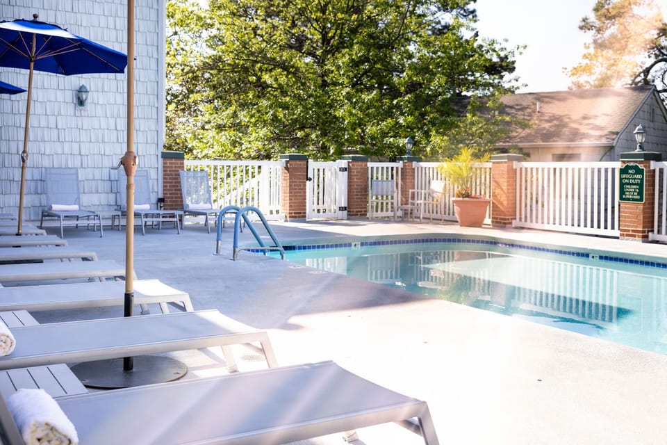 Tranquil waters and inviting lounge chairs set the scene for a peaceful retreat just steps from the shore.