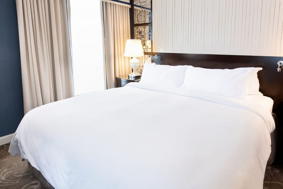 A serene escape, where plush bedding and soft lighting create the perfect space to unwind.