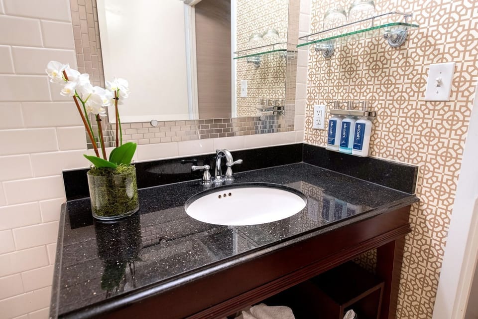 Elegant bathroom with modern touches, featuring sleek countertops and refined details for a refreshing stay.