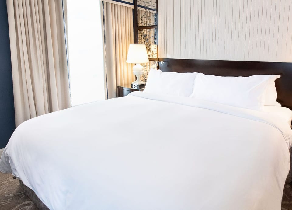 A peaceful retreat, where plush bedding and soft lighting create the perfect space to unwind.