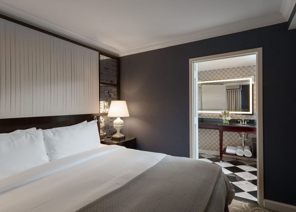 A refined retreat, where plush bedding and soft lighting create a perfect space for relaxation.