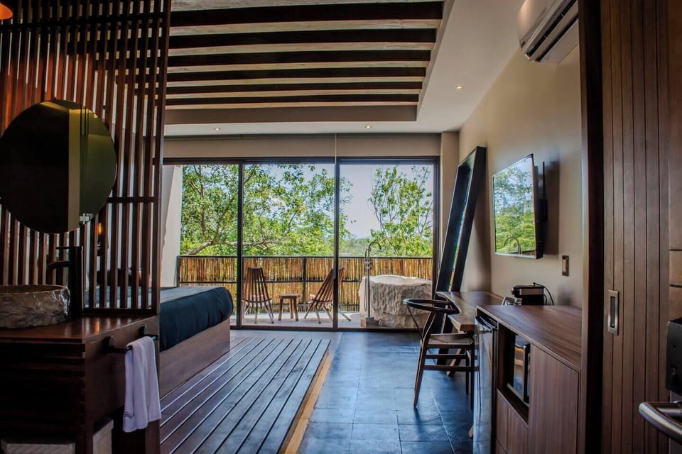 Step onto your private balcony, unwind in the tub, and enjoy stunning Tulum jungle views.
