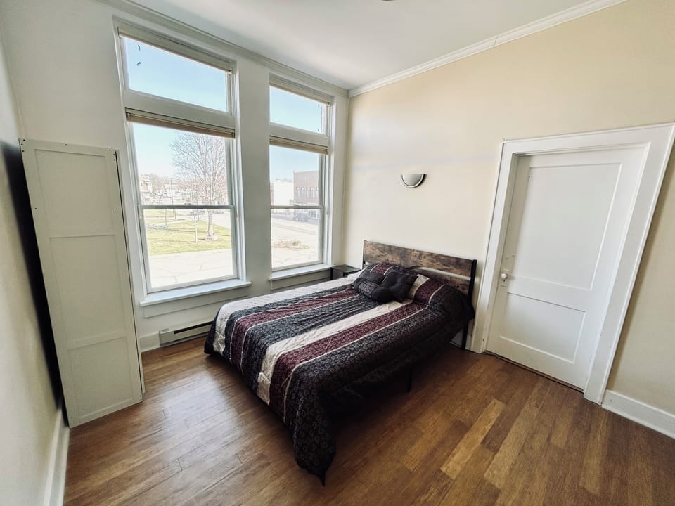 Bedroom with a queen bed overlooking the town square.
