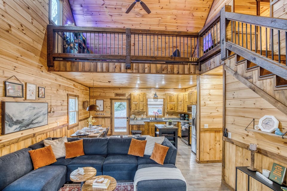 Enjoy a warm open cabin space w/ game area, kitchen & comfy seating.