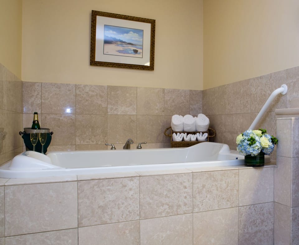A deep soaking tub offers the perfect place to unwind and refresh after a day by the beach.