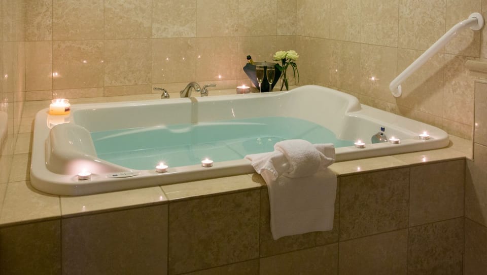 Soft candlelight and a deep soaking tub create the ultimate spa-like retreat.