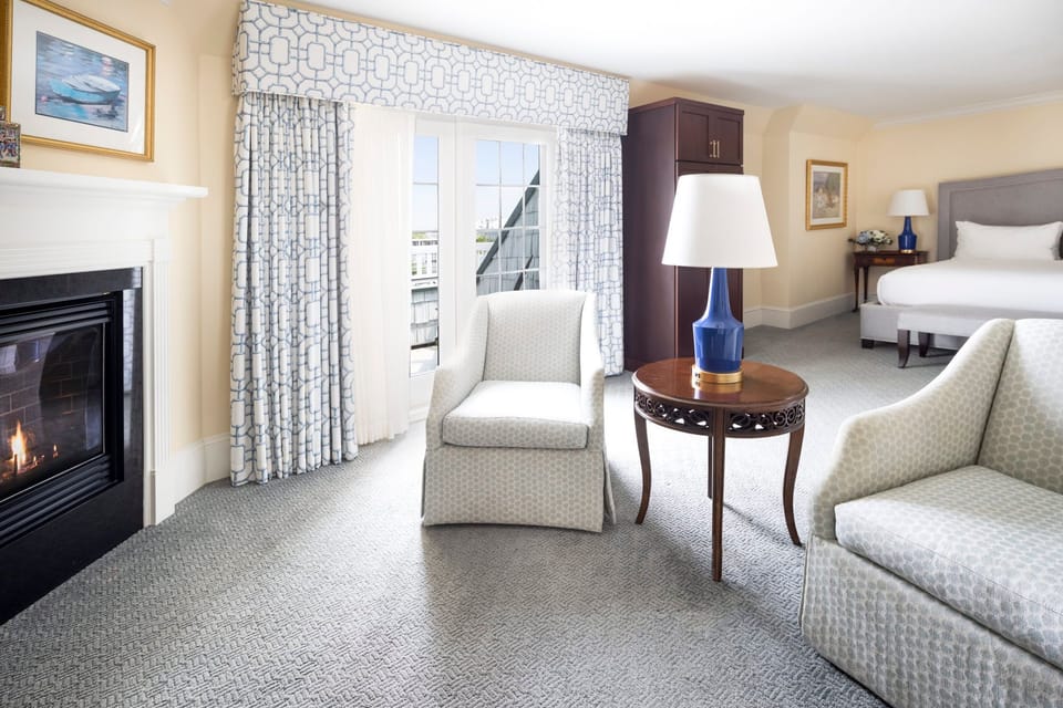 A bright and inviting suite featuring a cozy fireplace and elegant seating for ultimate relaxation.
