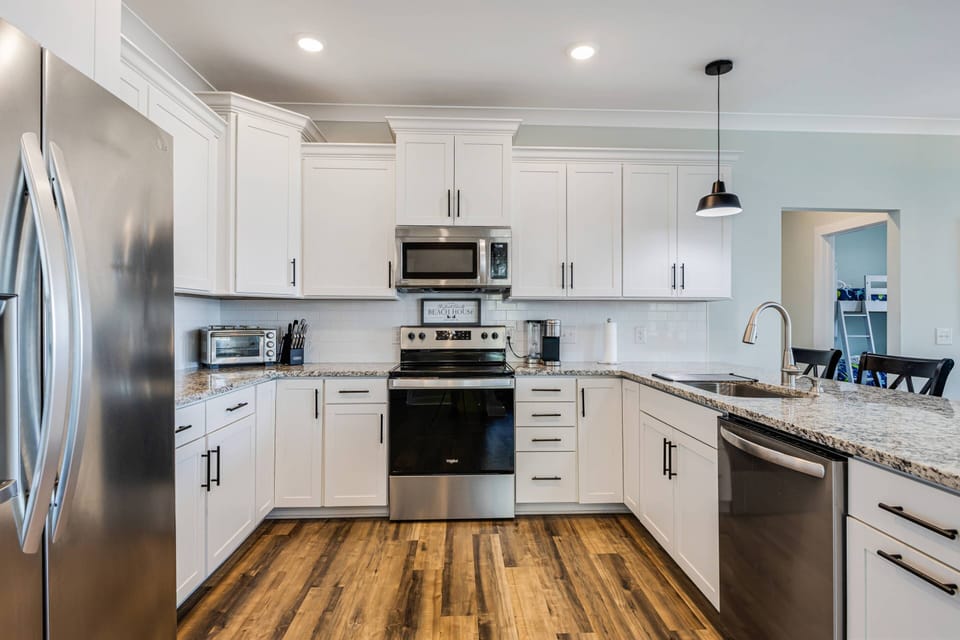 Kitchen with complete appliances spacious countertops for easy meal preparation.