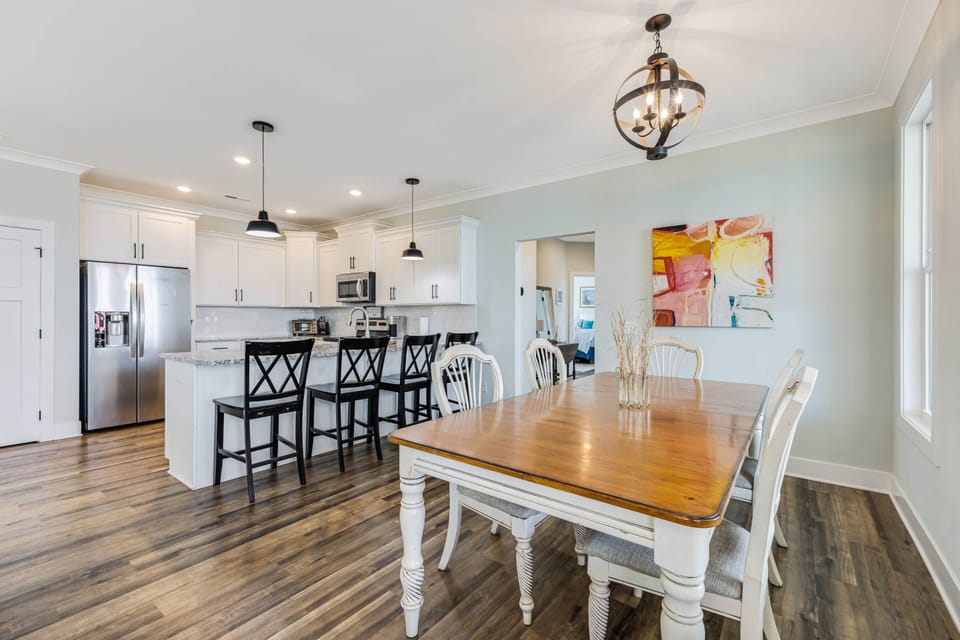 Open kitchen area with a dining space that seats 6, plus a breakfast bar with seating for 4