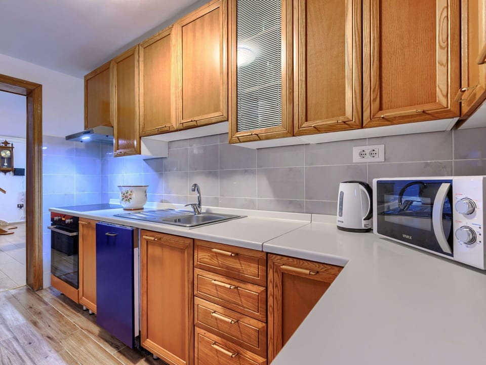 Furniture, Wood, Interior Design, Flooring, Kitchen, Cabinetry, Floor, Room, Major Appliance, Cupboard
