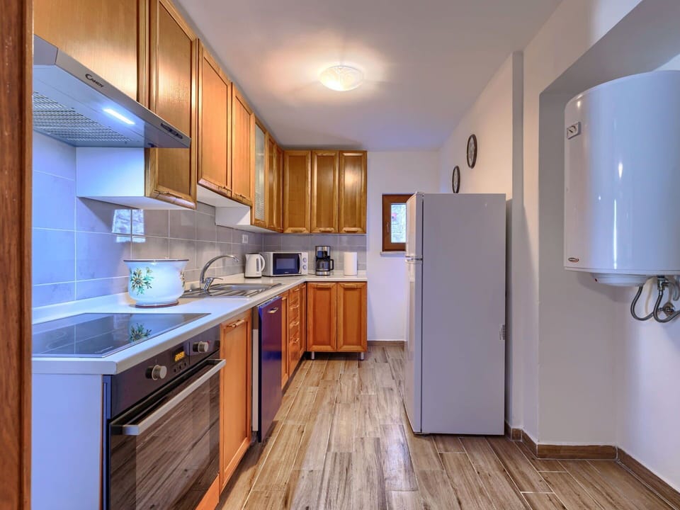 Furniture, Wood, Interior Design, Flooring, Kitchen, Cabinetry, Floor, Room, Major Appliance, Cupboard