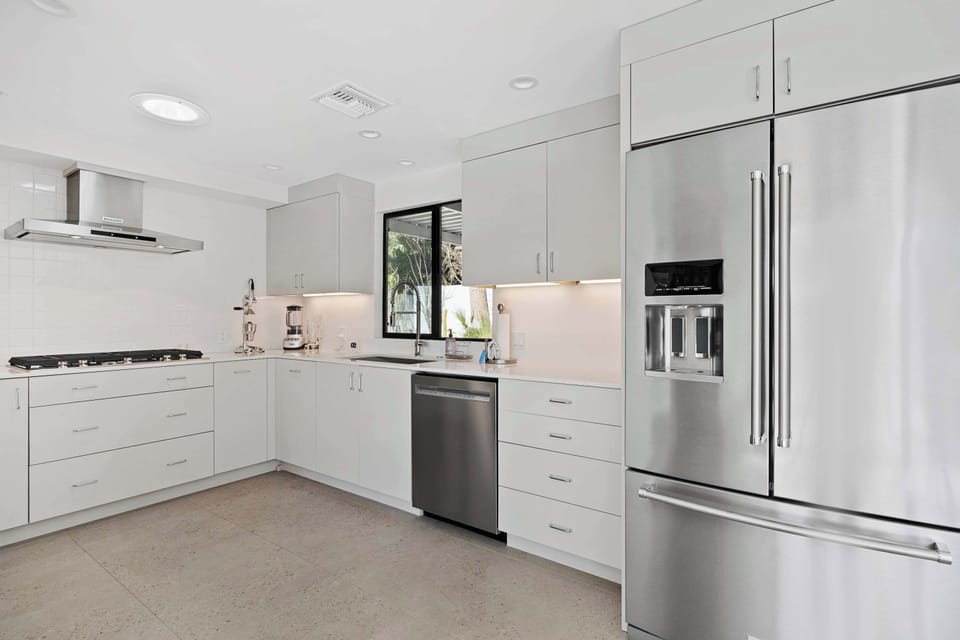 The sleek kitchen offers ample space & every home comfort