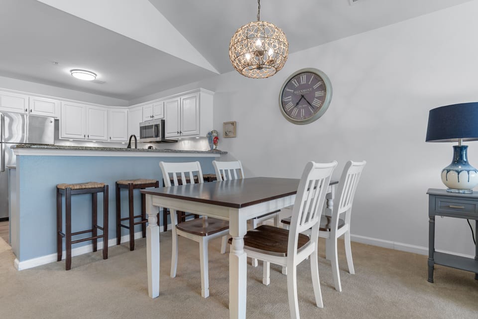 Gather around your spacious dining table for memorable meals, with a fully equipped kitchen featuring granite counters and modern appliances at your fingertips.