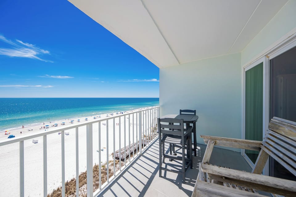 Enjoy stunning beachfront views from the balcony, featuring stylish outdoor seating for relaxation and dining
