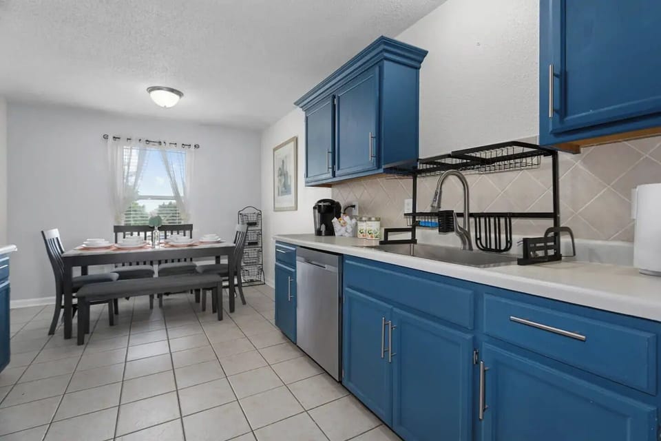 The spacious layout includes a well-organized countertop, providing ample space for meal preparation. A charming dining table with matching chairs sits in the center, inviting guests to enjoy meals together 