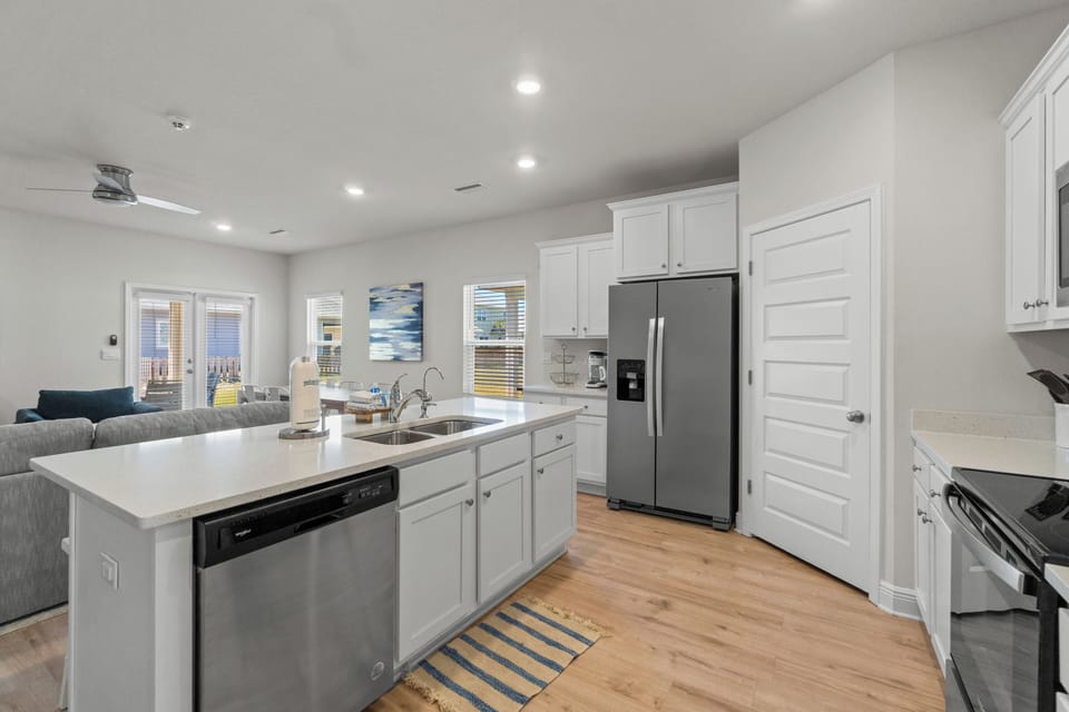 Cook with ease in your bright, modern kitchen featuring stainless steel appliances and spacious quartz countertops perfect for meal prep.