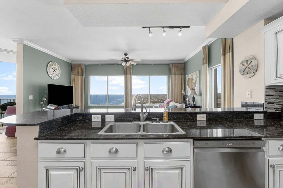 The full kitchen in this vacation rental is designed for both convenience and style, offering everything you need to whip up a delicious meal while enjoying stunning views.