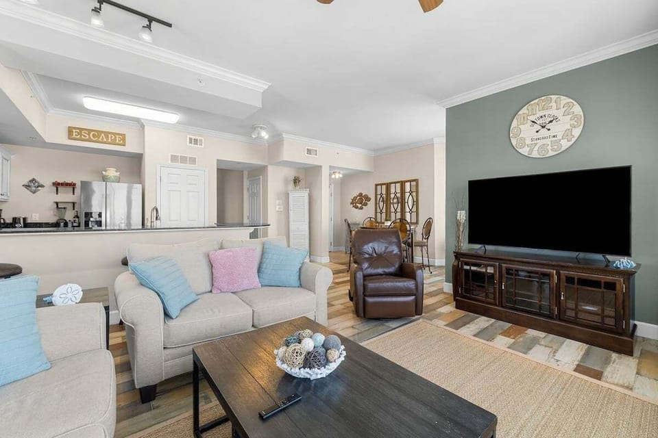Gather with family and friends in this stylish retreat. Floor-to-ceiling windows flood the space with natural light.