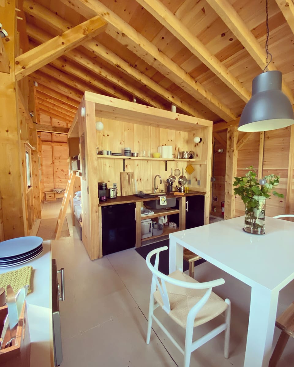 Kitchenette has frig/freezers, induction cooktop, & combo mw/oven/air-fry.