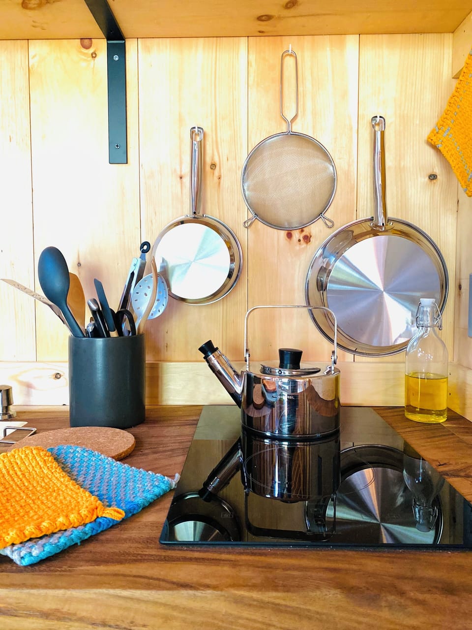 Utensils, pots, pans, potholders.  The teapot boils water quickly on induction.