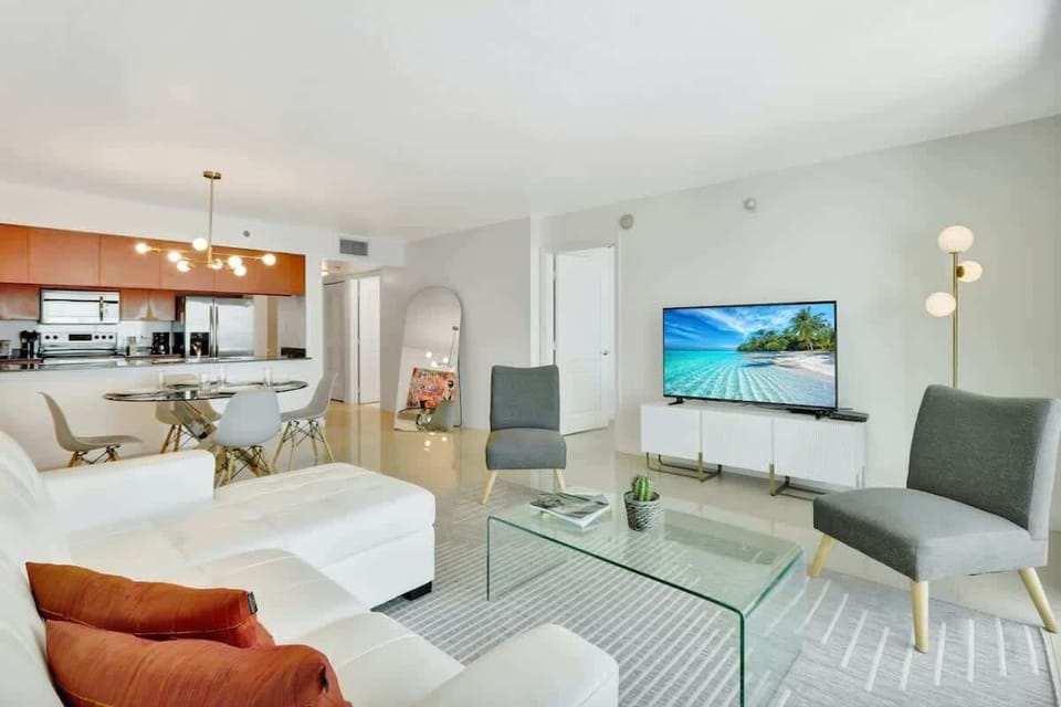 Pristine living room enriched with an abundance of natural light from floor to ceiling window!