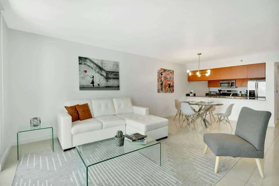 Pristine living room enriched with an abundance of natural light from floor to ceiling window!