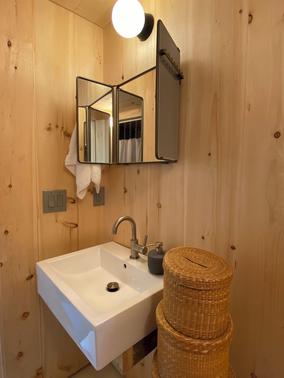 Another view of the bathroom, which has a hair dryer. 