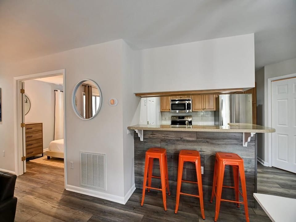 A stylish kitchen with bar seating and modern lighting, perfect for casual dining or entertaining.