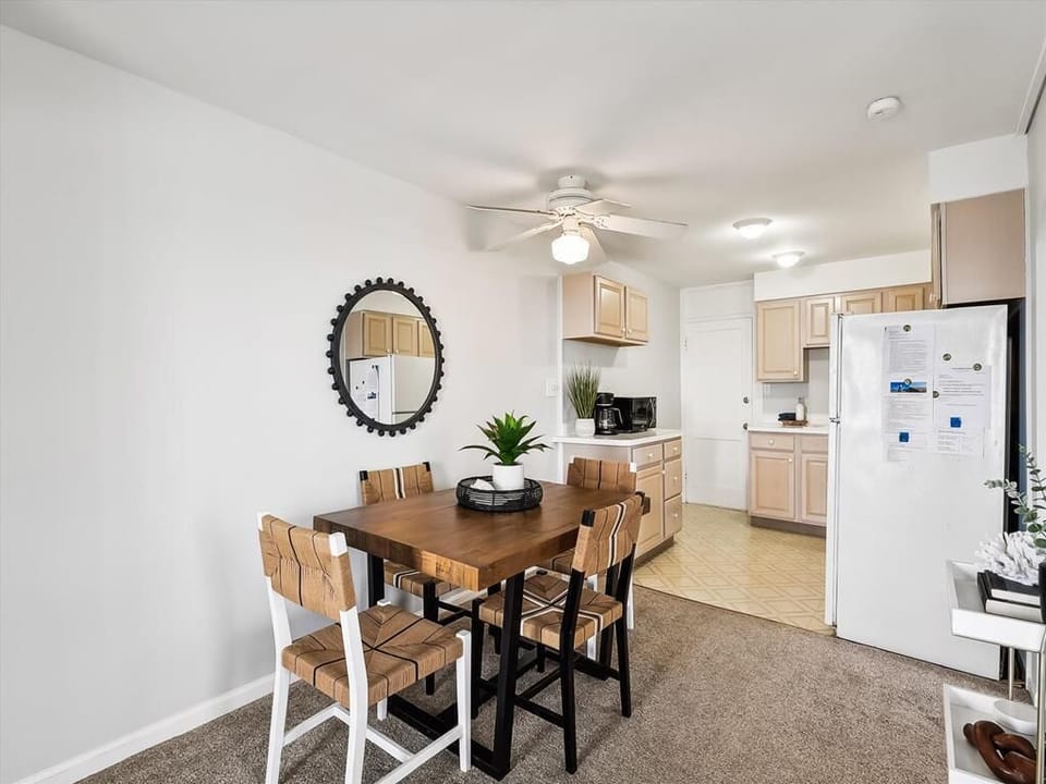 Bright dining space with a ceiling fan, ideal for cozy meals after a day on the boardwalk.