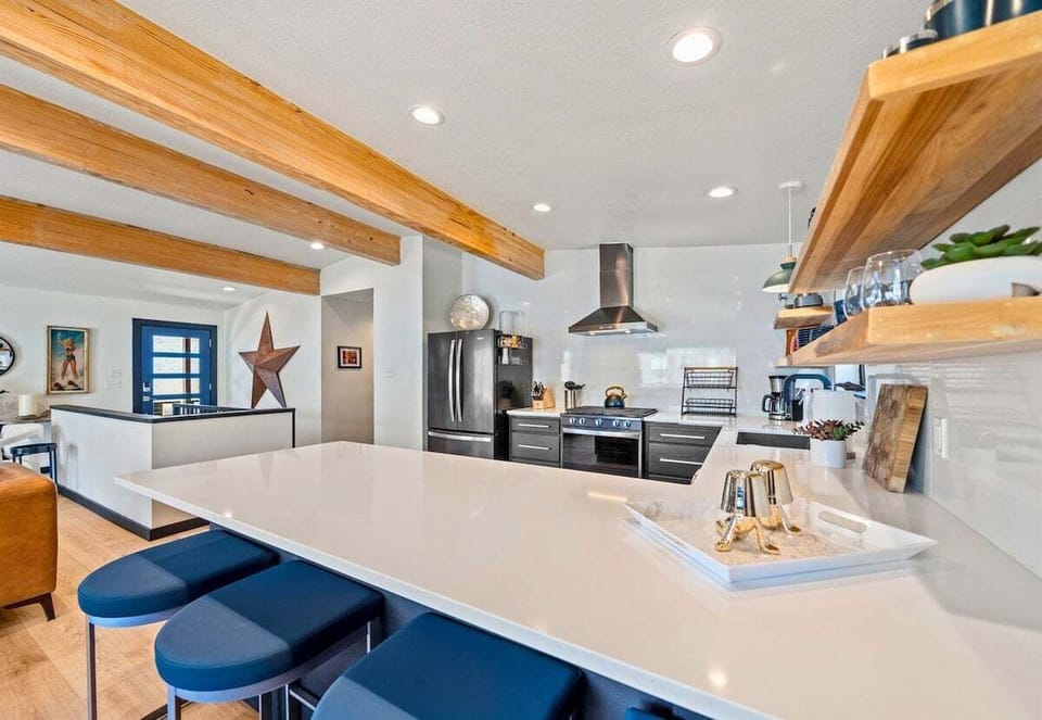 Sleek countertops and contemporary touches make this kitchen as beautiful as it is practical—perfect for any culinary endeavor.