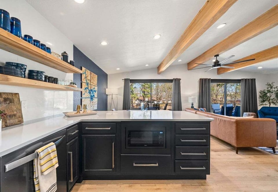 Warm wood accents and stylish cabinetry make this light-filled cooking space both inviting and functional.