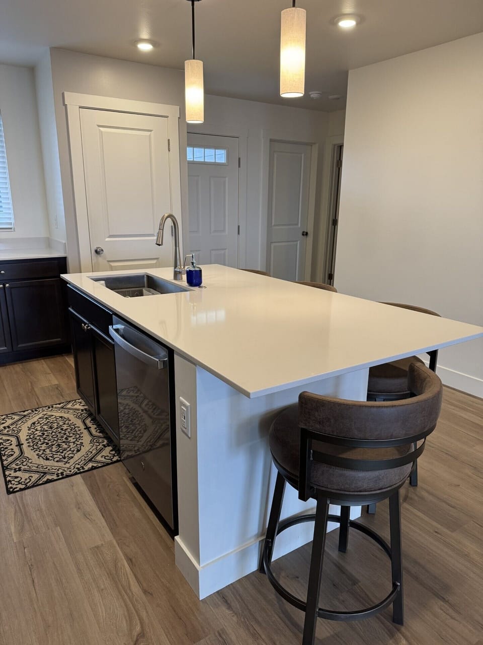 Large island with Quartz countertop seats 4 comfortably.