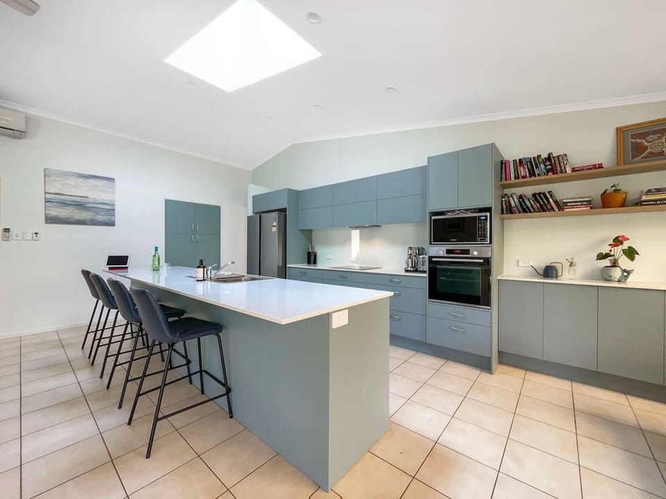 The kitchen centres around an island with seating for four.