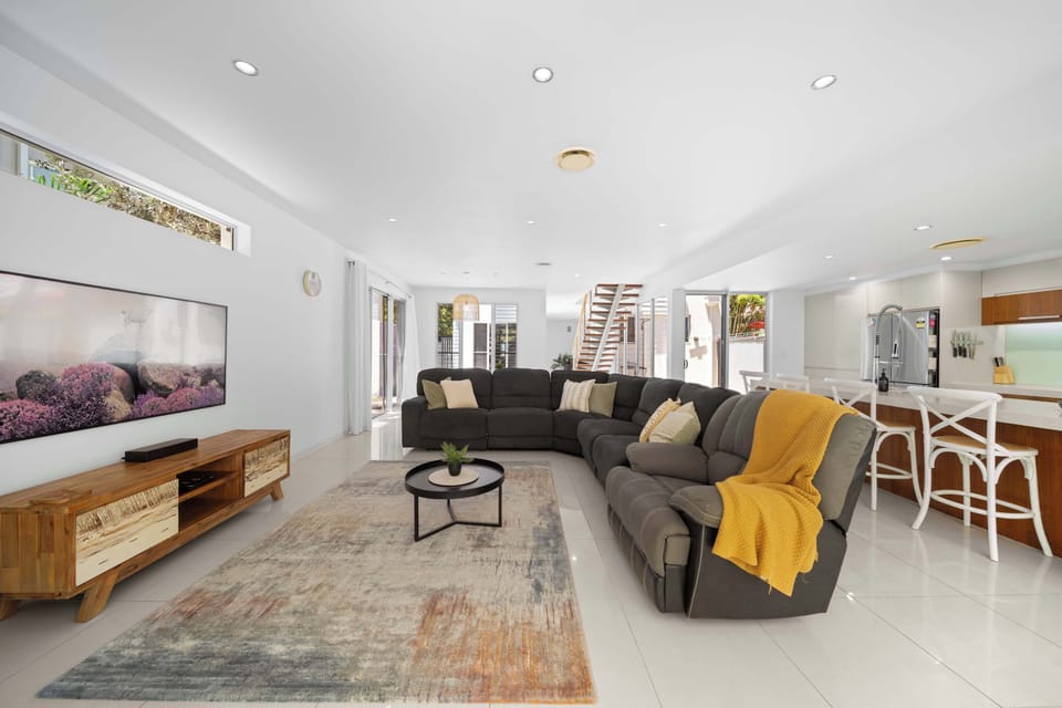 Stretch out and unwind in this breezy, sun-filled living room where morning coffee turns into lazy afternoons with a book or a movie.