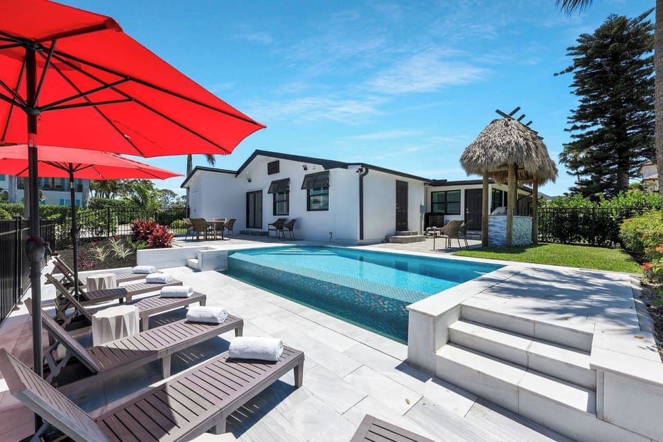 Step into your private Naples escape — sun-kissed pool, lush palms, and peaceful canal views set the tone for relaxation