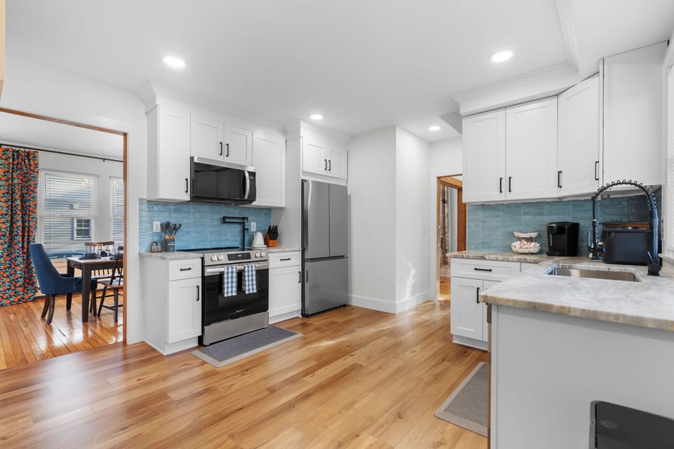 Fully stocked kitchen with pot filler, air fryer, coffee maker & cooking tools.