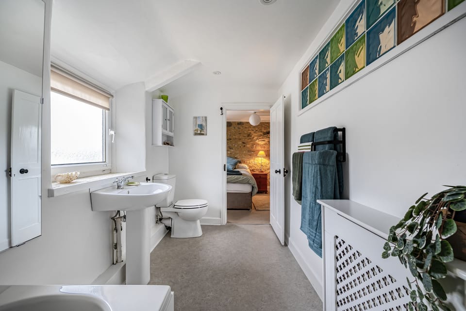 Meads Cottage, Charmouth: The well lit bathroom can be accessed from both bedrooms
