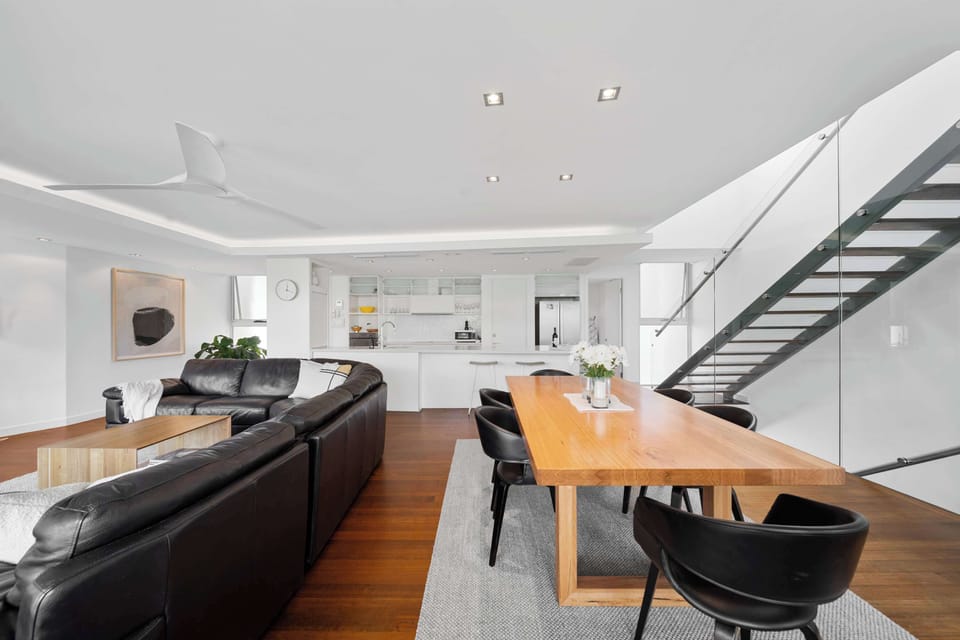 Spacious, open-plan living room with a 75" Smart TV.