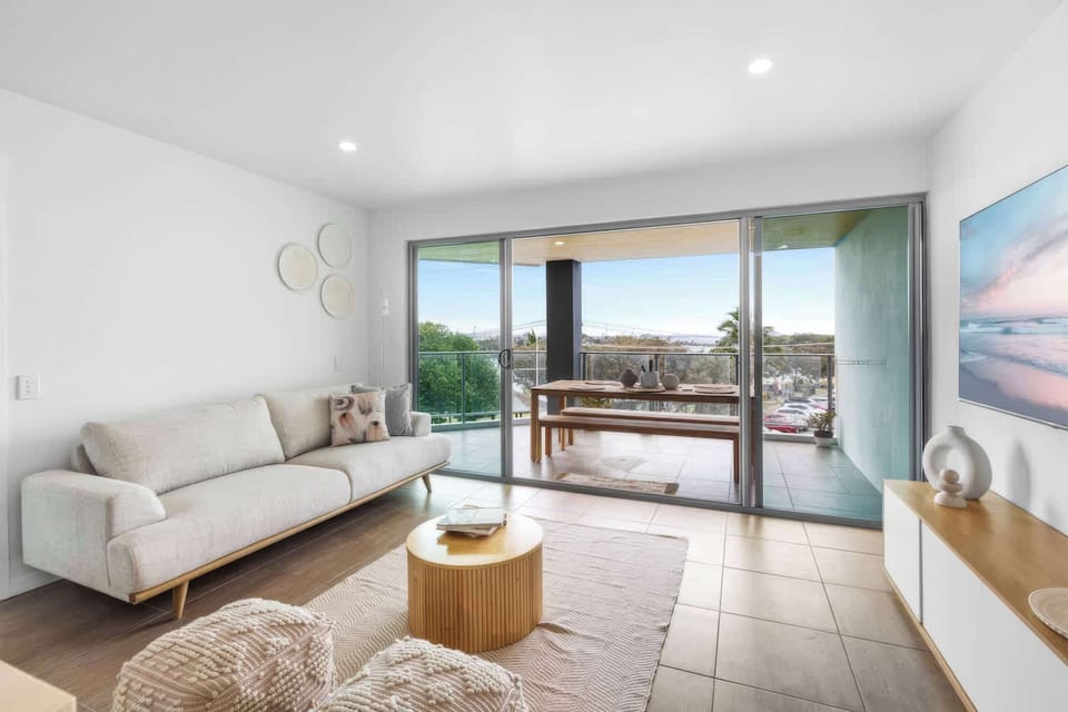 Bright open plan living area with beautiful river and marina views