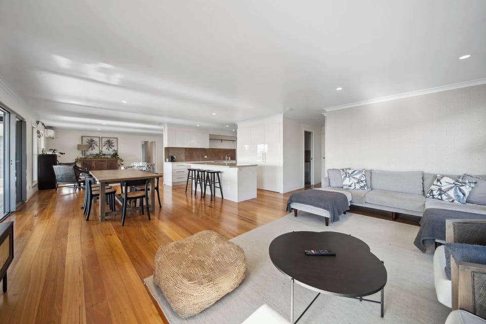 The open-plan living and dining space is warm, welcoming and filled with natural light.