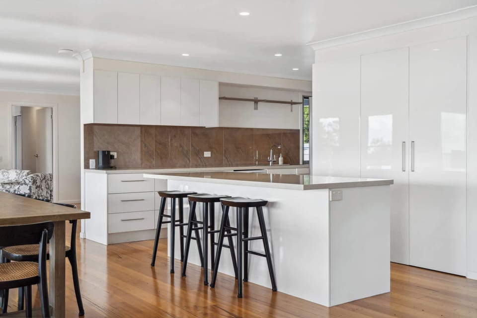 The kitchen offers ample bench space with casual seating at the breakfast bar.