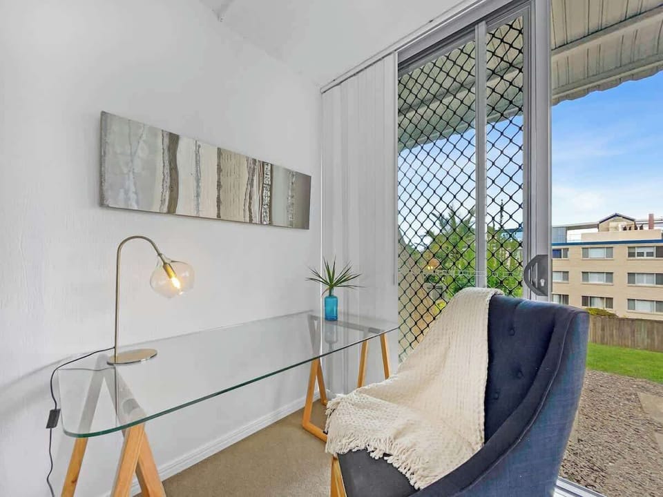 A dedicated workspace in the first bedroom offers a quiet spot for Zoom calls or to ready yourself before hitting the local Surf Club for a meal.