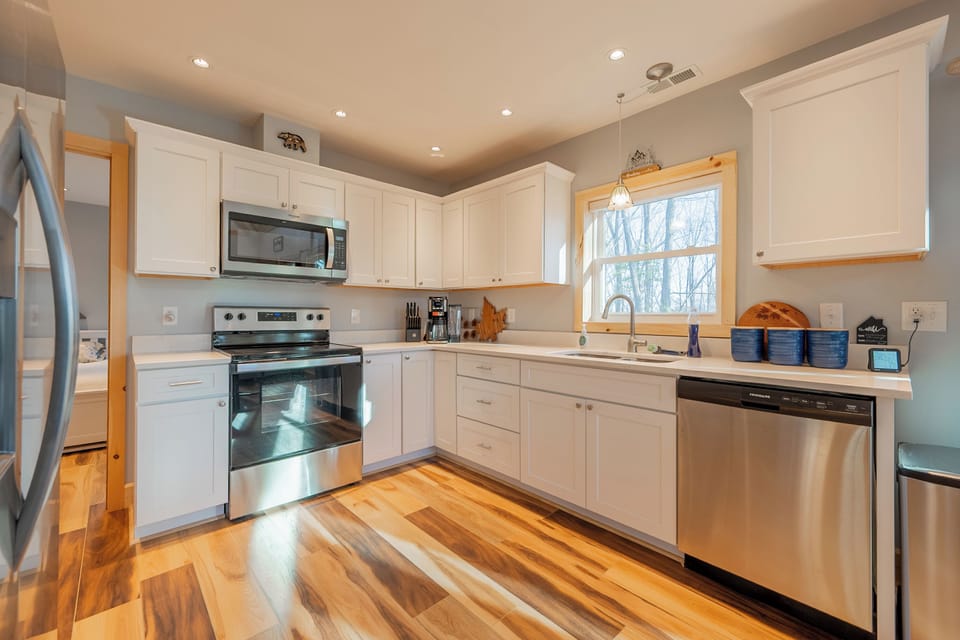 Fully stocked kitchen with stainless steel appliances and modern touches.