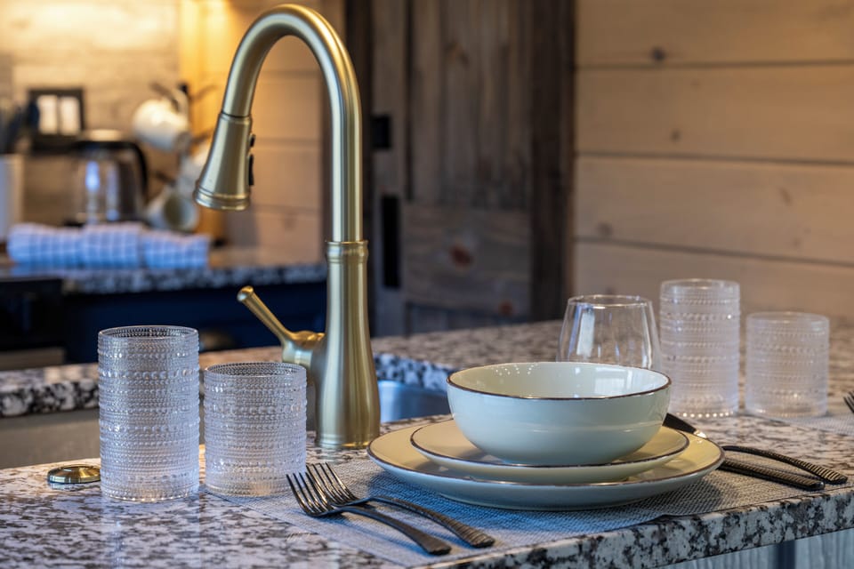 Set for two with stylish dishware and a touch of gold—perfect for a cozy meal in.
