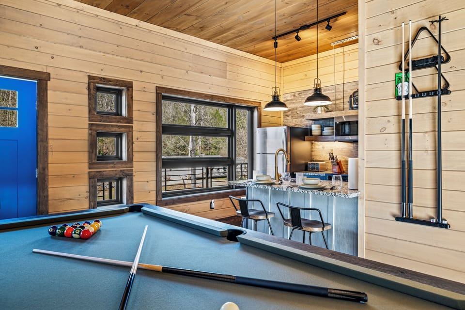 This cozy cabin layout keeps you connected—prep a meal while your friends line up their next shot.