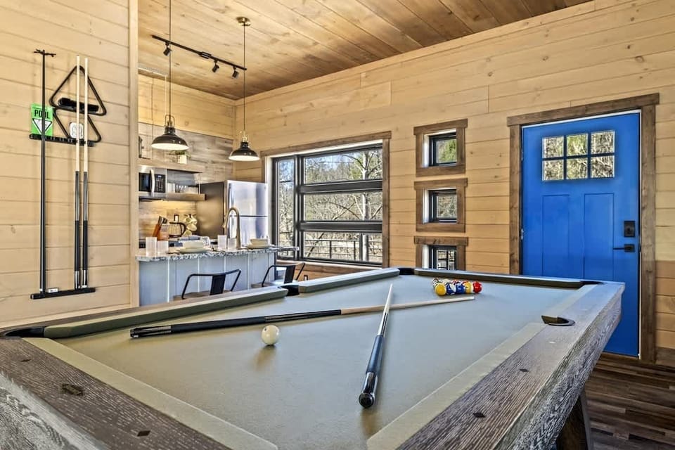 This cozy cabin layout keeps you connected—prep a meal while your friends line up their next shot.
