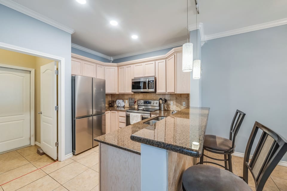 Your modern kitchen awaits with granite counters and sleek appliances for effortless meal prep.